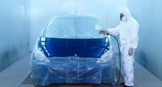 Vehicle masked and prepped for painting in the spray booth